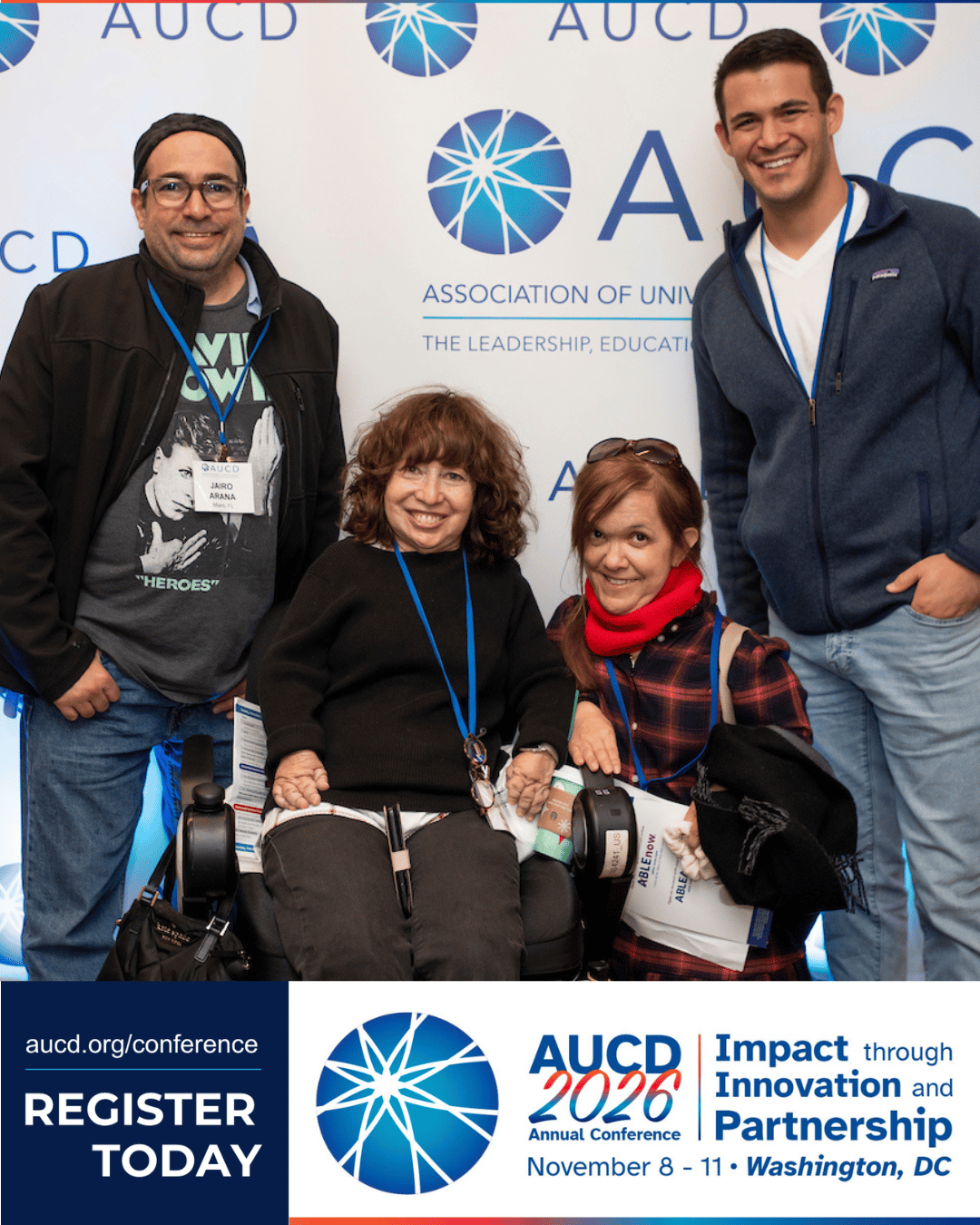 Group of five people posing at an AUC D 2026 conference backdrop, with conference branding and a “Register Today” banner at the bottom.